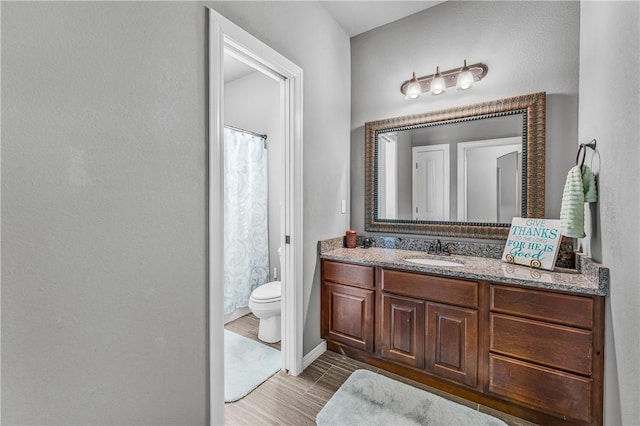 full bathroom featuring vanity, curtained shower, and toilet