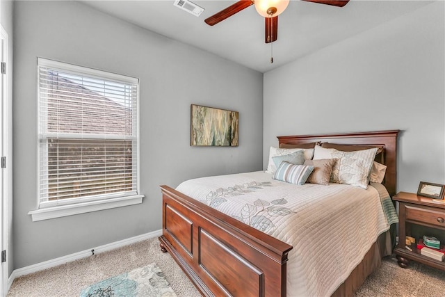 bedroom featuring ceiling fan, baseboards, visible vents, and light carpet