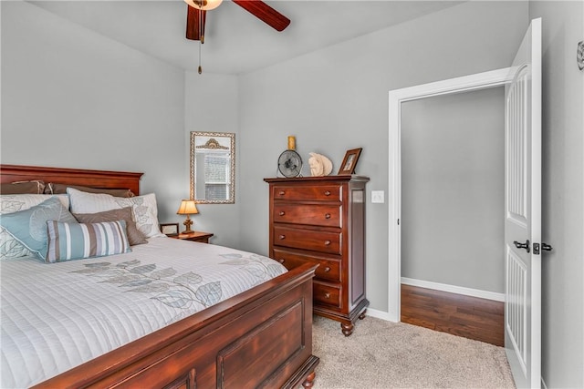 carpeted bedroom featuring baseboards and ceiling fan