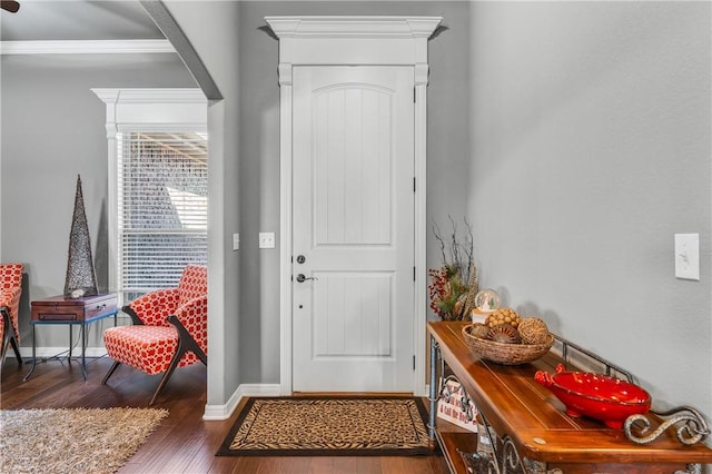 entryway featuring baseboards and wood finished floors