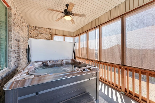 sunroom / solarium with wood ceiling and a hot tub