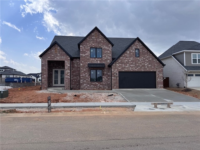 traditional-style home with concrete driveway, brick siding, and a shingled roof