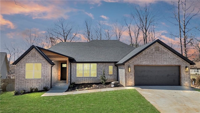 view of front of property with concrete driveway, a garage, brick siding, and a front yard