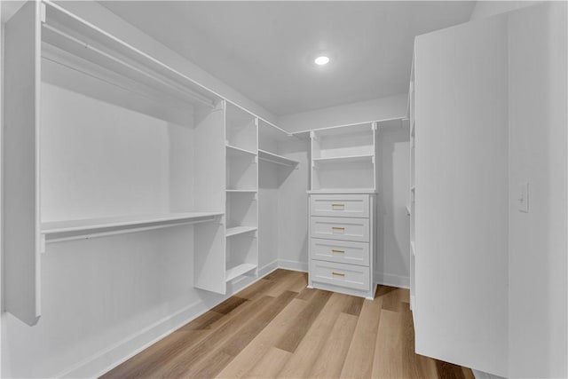 walk in closet with light wood-type flooring