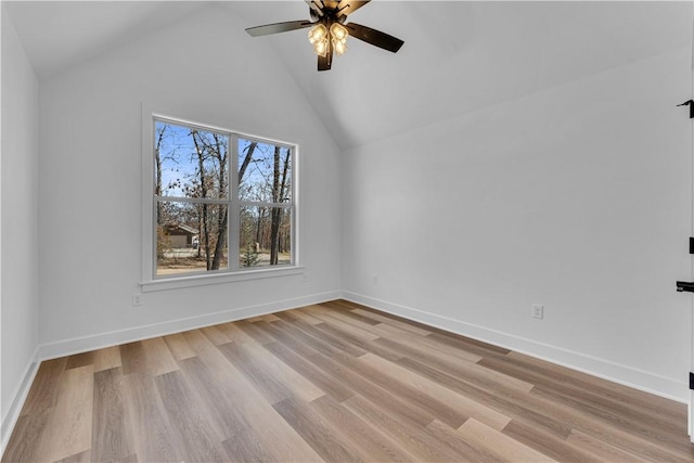 unfurnished room featuring a ceiling fan, baseboards, light wood finished floors, and high vaulted ceiling