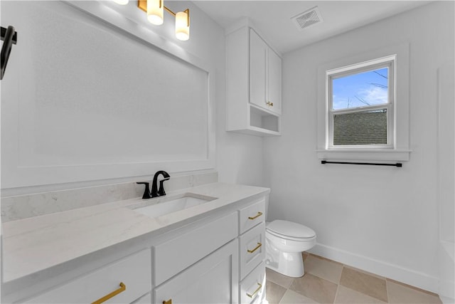 bathroom with visible vents, toilet, vanity, and baseboards