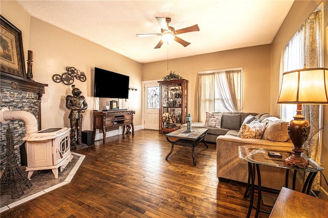 living area with dark wood-style floors, baseboards, a textured ceiling, and a ceiling fan