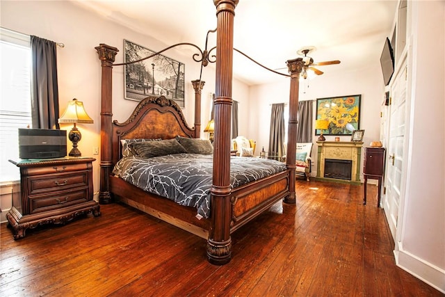 bedroom featuring a fireplace and hardwood / wood-style floors