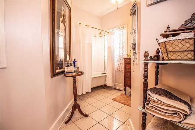 bathroom with tile patterned floors, shower / tub combo, and baseboards