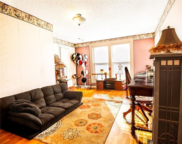 living room with a textured ceiling and wood finished floors