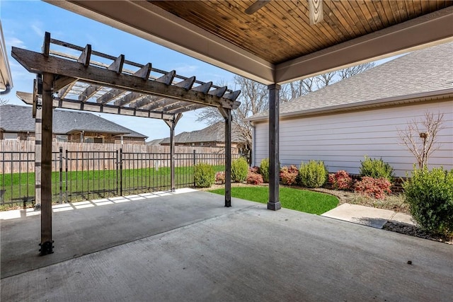 view of patio with a pergola and fence