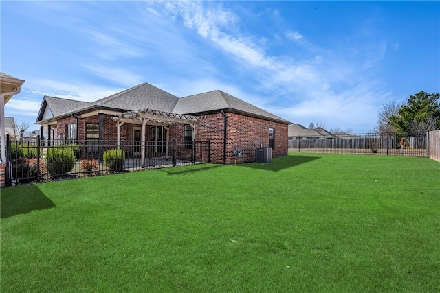 back of property featuring brick siding, a lawn, a pergola, and fence