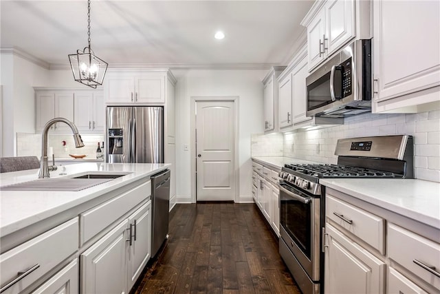 kitchen with a sink, white cabinetry, appliances with stainless steel finishes, crown molding, and light countertops