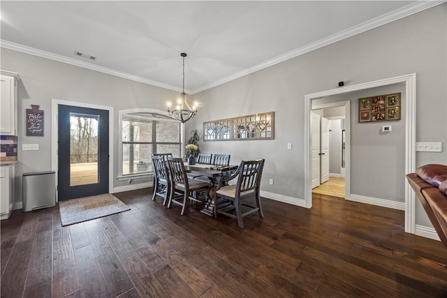 dining space with an inviting chandelier, visible vents, dark wood-style flooring, and ornamental molding