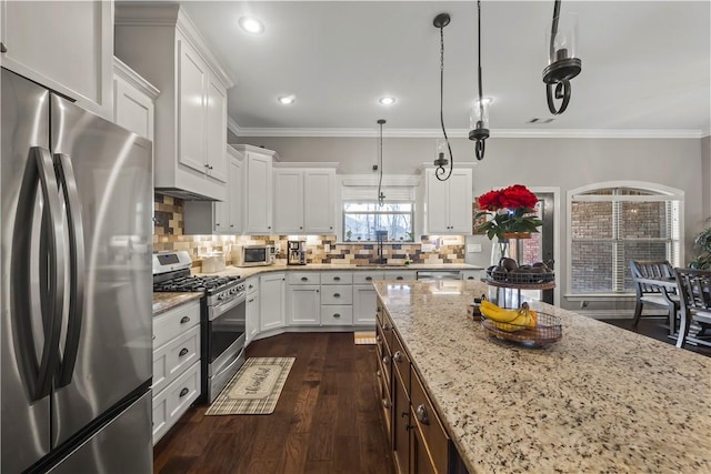 kitchen featuring tasteful backsplash, dark wood-type flooring, ornamental molding, light stone counters, and appliances with stainless steel finishes