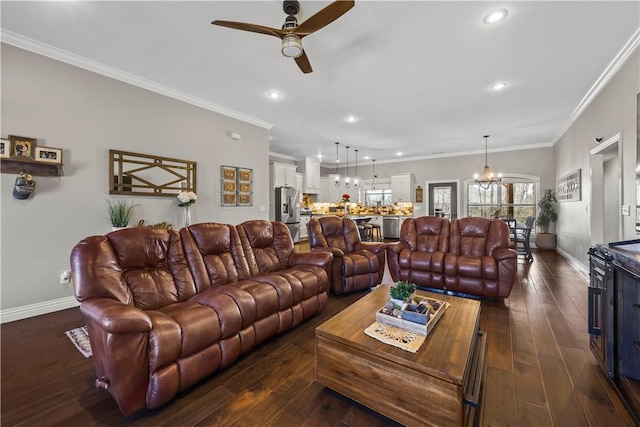 living room with baseboards, ornamental molding, dark wood-style flooring, and ceiling fan with notable chandelier