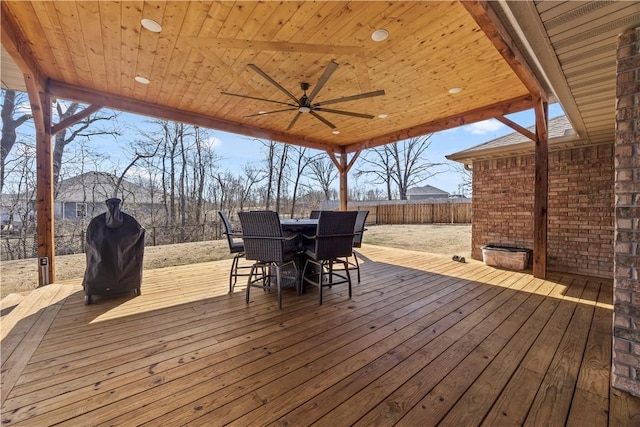 wooden terrace with outdoor dining space, a ceiling fan, and fence