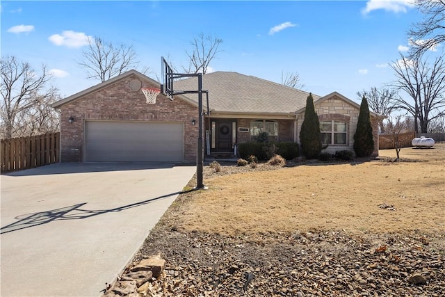 single story home featuring concrete driveway, an attached garage, fence, and brick siding