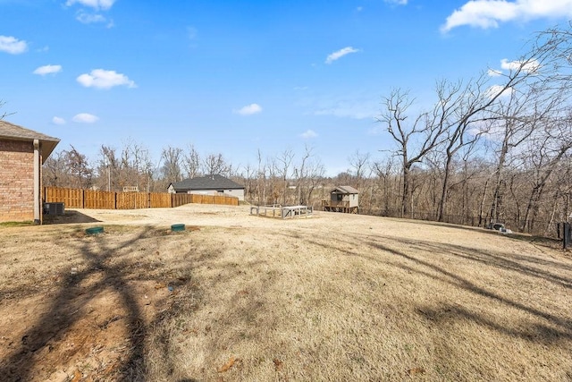 view of yard featuring central AC unit and fence