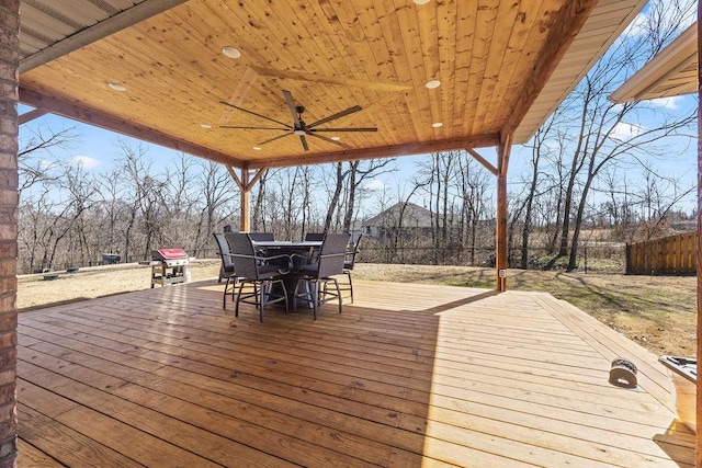 deck featuring outdoor dining space, a ceiling fan, and fence