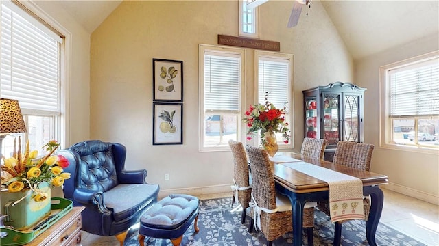 dining space with baseboards, ceiling fan, and vaulted ceiling