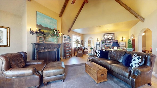 living area featuring high vaulted ceiling, an inviting chandelier, arched walkways, a high end fireplace, and beamed ceiling