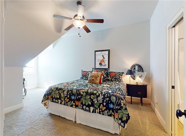 carpeted bedroom with vaulted ceiling, a ceiling fan, and baseboards