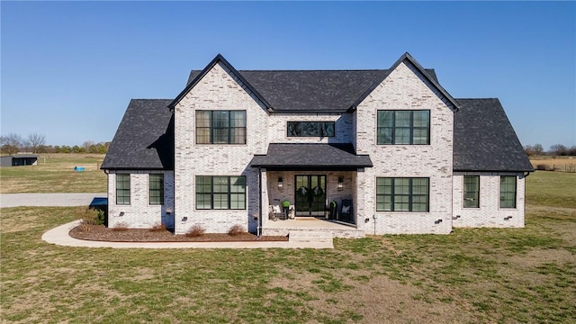 view of front of property with brick siding and a front lawn