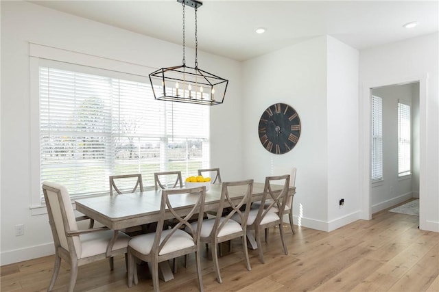 dining space featuring an inviting chandelier, recessed lighting, baseboards, and light wood finished floors