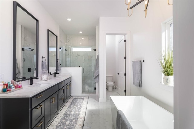 bathroom featuring toilet, marble finish floor, a sink, a marble finish shower, and a soaking tub