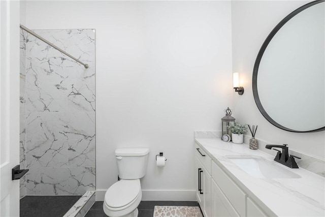 bathroom with a marble finish shower, baseboards, toilet, and vanity