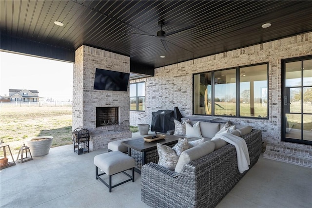 view of patio / terrace featuring an outdoor living space with a fireplace, a grill, and ceiling fan