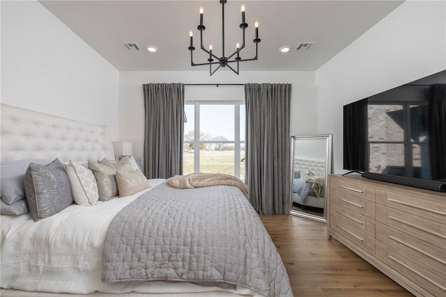 bedroom featuring a chandelier, visible vents, recessed lighting, and wood finished floors