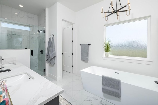 bathroom with a sink, an inviting chandelier, marble finish floor, and a healthy amount of sunlight