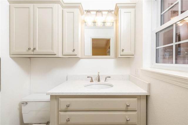 bathroom featuring vanity and toilet