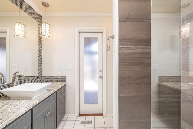 full bathroom featuring vanity, decorative backsplash, tiled shower, and ornamental molding