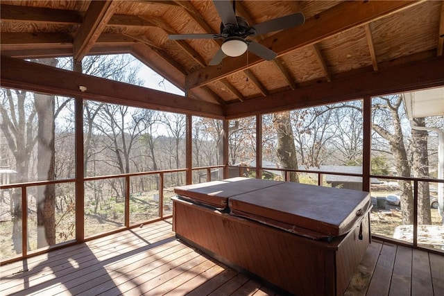 unfurnished sunroom with vaulted ceiling and a ceiling fan