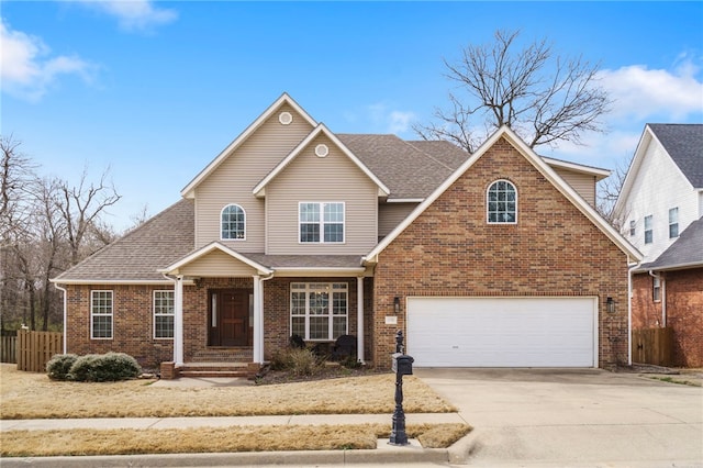 view of front of house with driveway, fence, roof with shingles, a garage, and brick siding