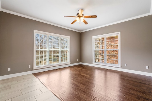 unfurnished room featuring ornamental molding, baseboards, a ceiling fan, and wood finished floors