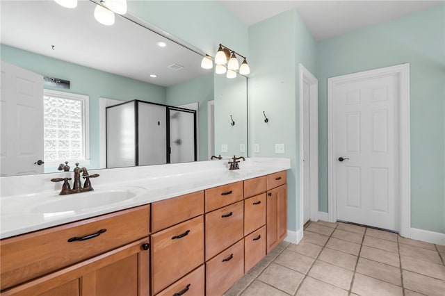 bathroom with tile patterned flooring, a stall shower, double vanity, and a sink