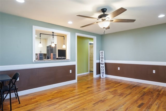 spare room with recessed lighting, wood finished floors, baseboards, and ceiling fan