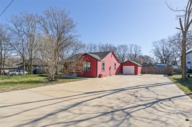 single story home featuring fence, concrete driveway, an outdoor structure, a garage, and crawl space