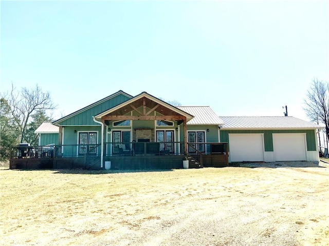 view of front of property with covered porch, metal roof, and a standing seam roof