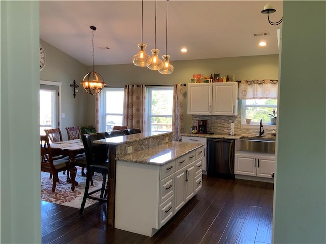 kitchen with dishwasher, dark wood-type flooring, visible vents, and a sink