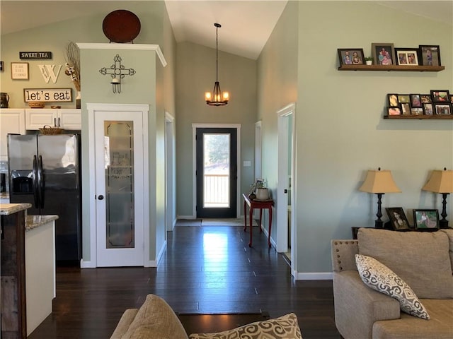 entrance foyer with high vaulted ceiling, baseboards, dark wood-style flooring, and a chandelier