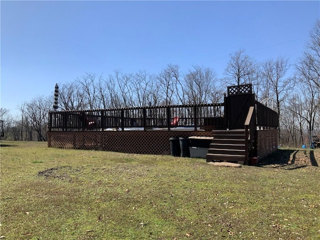 rear view of property with a lawn and a deck