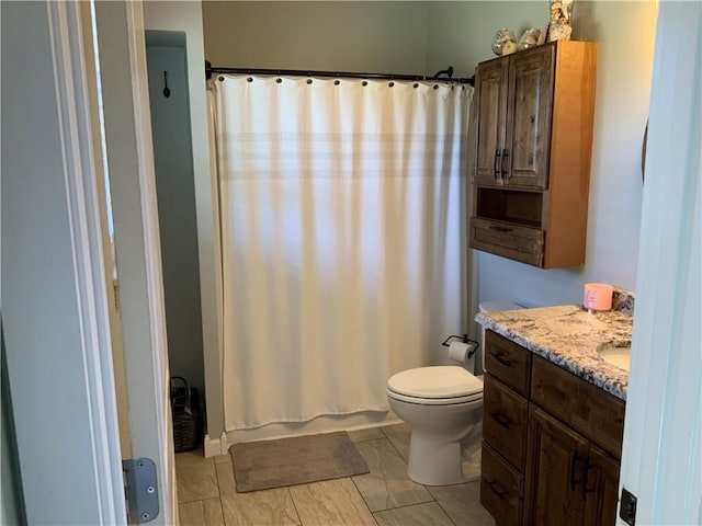 bathroom featuring a shower with curtain, toilet, and vanity