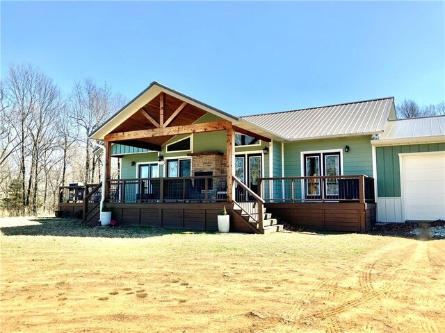 view of front of house with a garage and metal roof