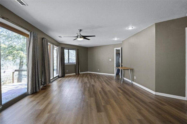 empty room with visible vents, baseboards, a ceiling fan, and wood finished floors