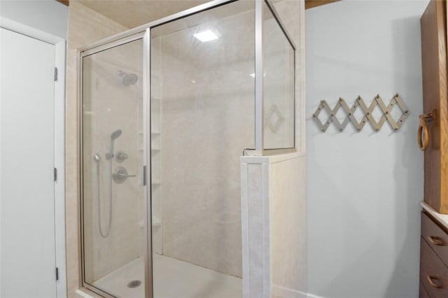 bathroom featuring vanity and a shower stall